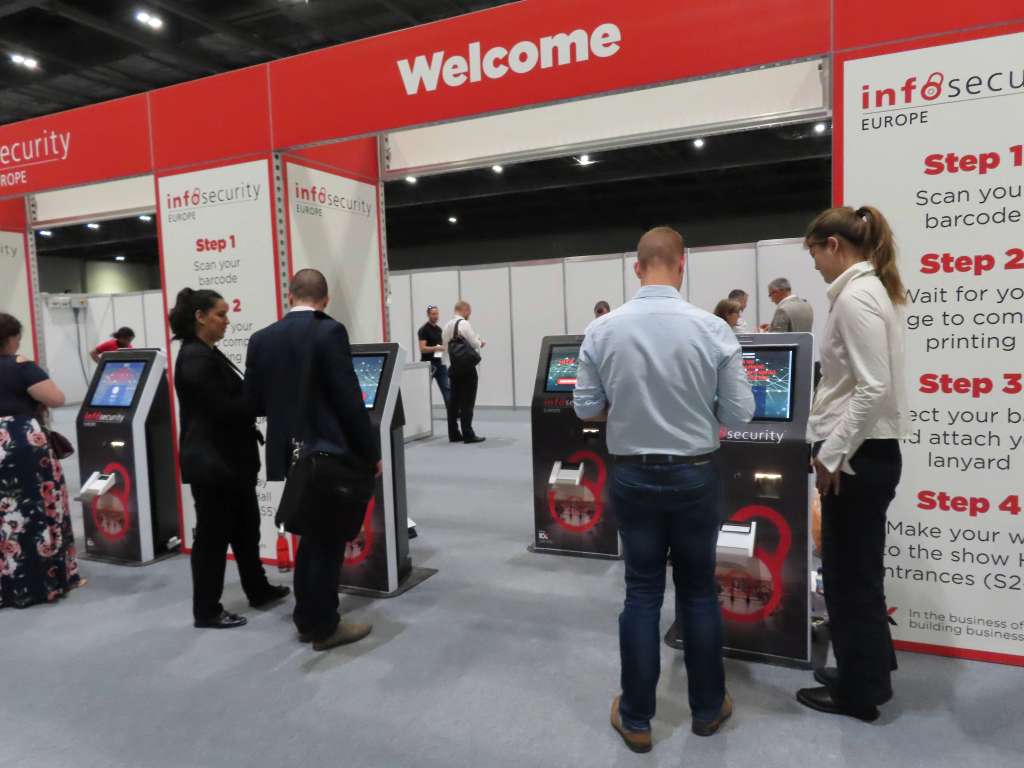 Staff helping visitors with koisk